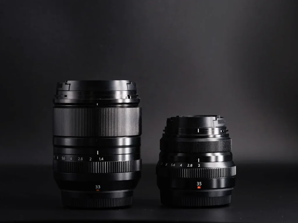 Fuji 33mm 1.4wr lens sat next to the smaller Fujifilm 35mm f2 lens. 