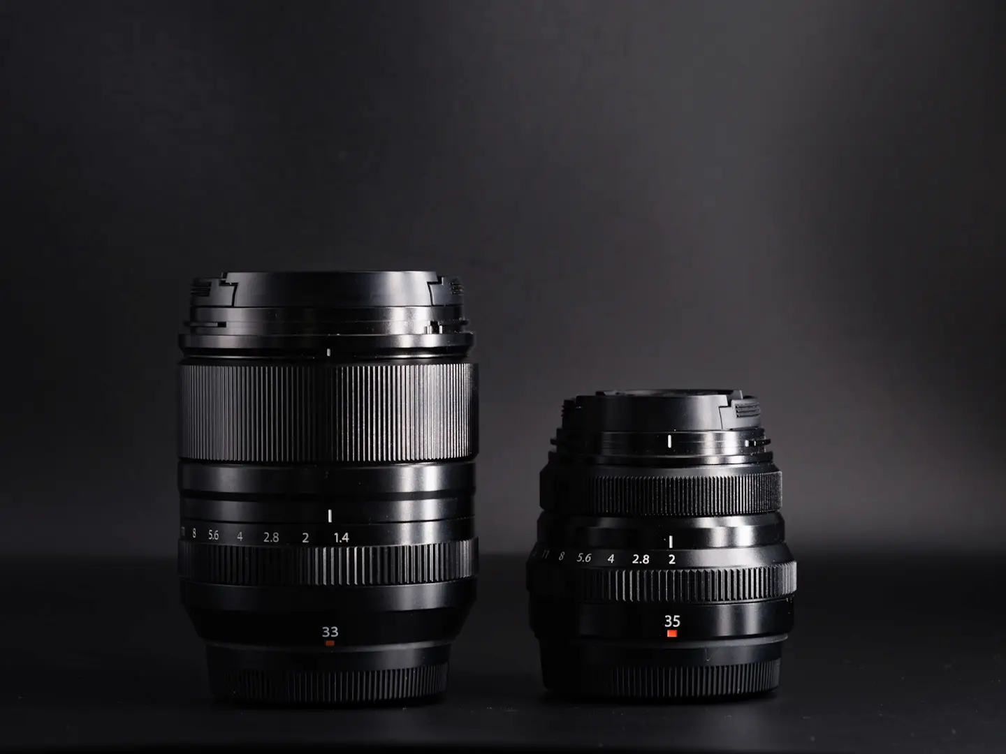 Fuji 33mm 1.4wr lens sat next to the smaller Fujifilm 35mm f2 lens.