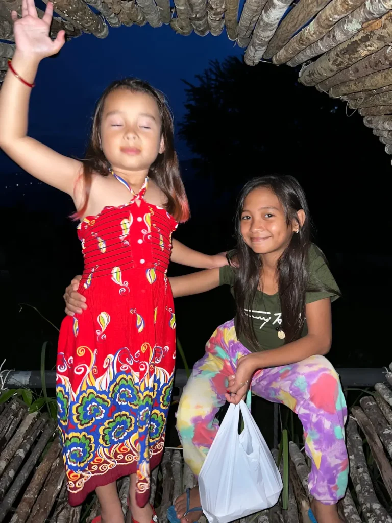 A photo of two girls taken on an iPhone at night showing the phones limitations.