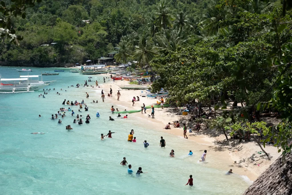 a beautiful secluded beach in the Philippines with turquiose water and golden sands. 