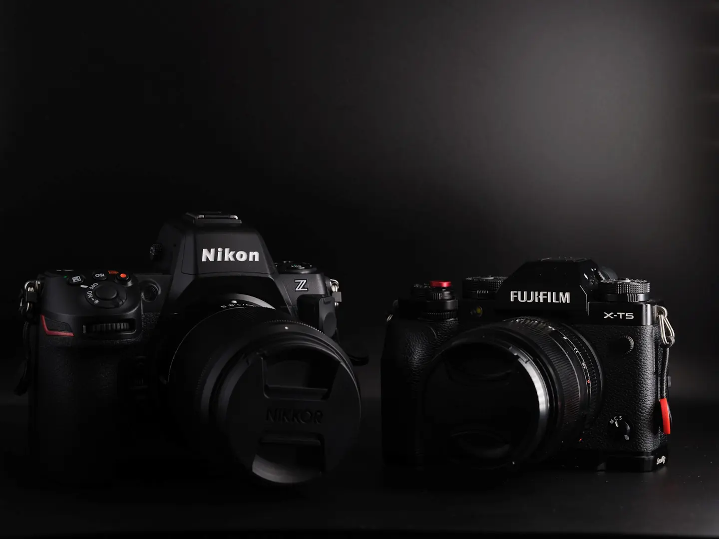 The Fujifilm X-T5 next to the Nikon Z8 on a black background.