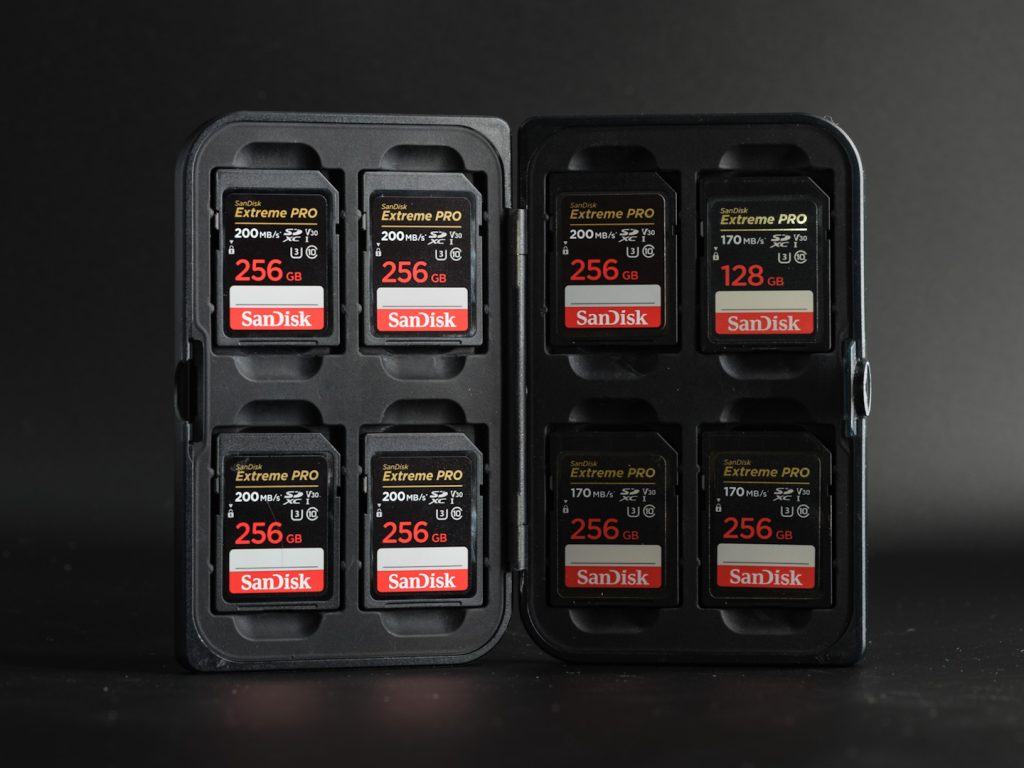 A lowepro case full of Sandisk SD cards photographed on a black background.
