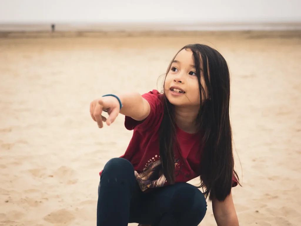 Sofia at Black Rock beach, Porthmadoc, Wales. This photo was taken on an OM Systems OM1 Mark II and 12-40mm f/2.8 Pro lens.
