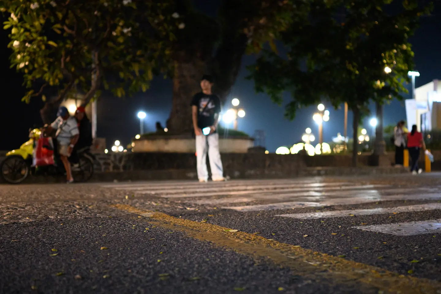 A night time photo of a zebra crossing in Dumaguete looking towards the boulevard. Photo taken on the Nikon Z6III camera to test high ISO performance.