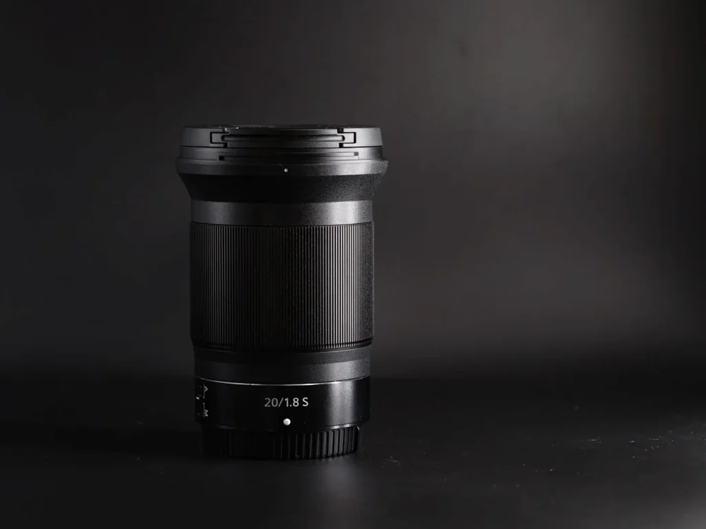 Nikon Z 20mm f/1.8S lens photographed on a black background. 