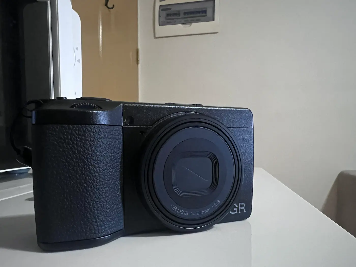 The Ricoh GRIV camera on a table.