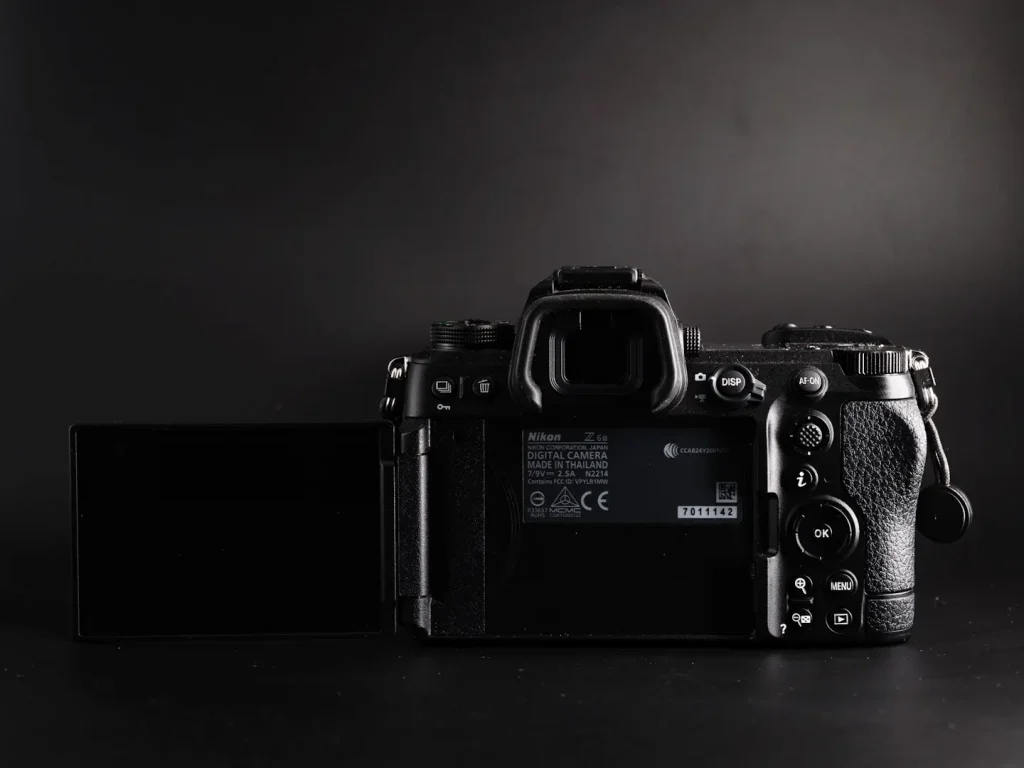 The rear articulating screen folded out on the Nikon Z6III camera. Photo is taken on a black background. 