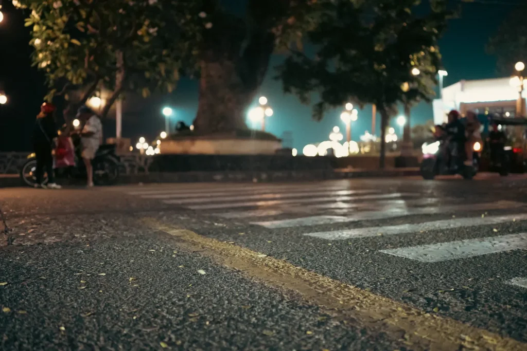 A zebra crossing shot from low down in Dumaguete city with scooters in the background. 