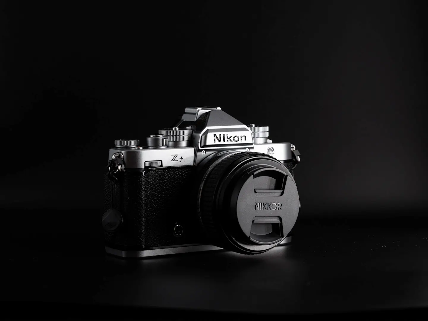 The Nikon ZF camera photographed on a black background in dramatic light.
