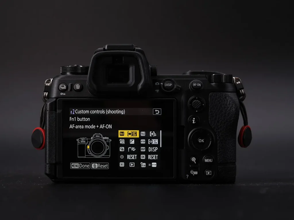 The rear screen of a Nikon Z6III showing the best custom settings for wildlife photography and the custom button confirguration. Phot is taken on a black background and in dramatic light. 