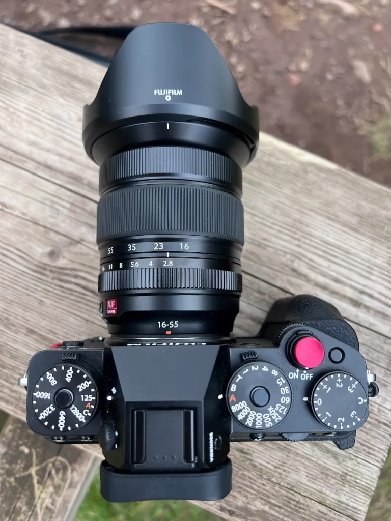 Top view of the Fujifilm 16-55mm f/2.8 II mounted on to a Fuji X-T5 camera. 