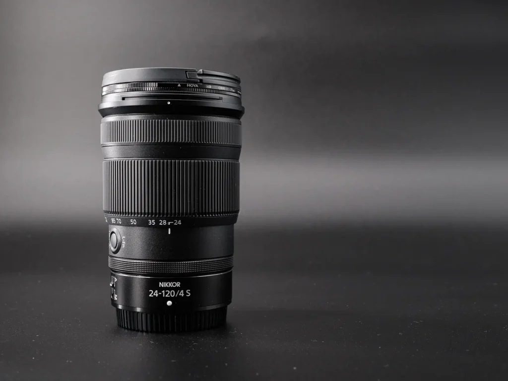 The Nikon Z 24-120mm f/4 S lens photographed against a black background. 