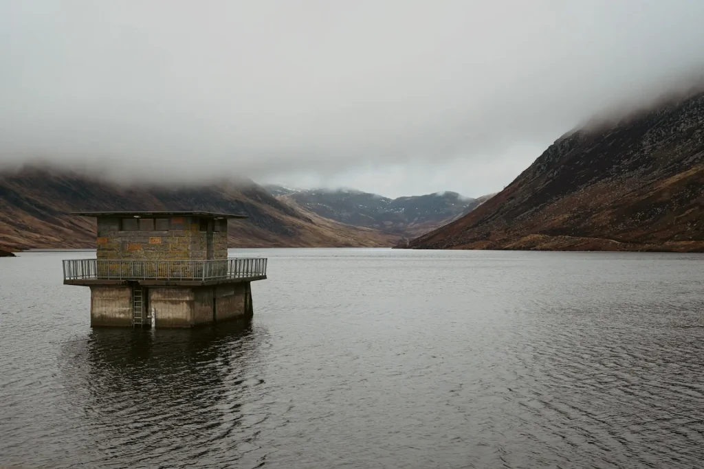 The water tower at Loch Turrett with mountains in the background. 