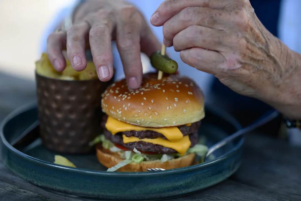 A close up shot of a burger and fries at a pub lunch. Photo is taken on the Nikon Z6III + Nikon Z 85mm 1.8S lens. 
