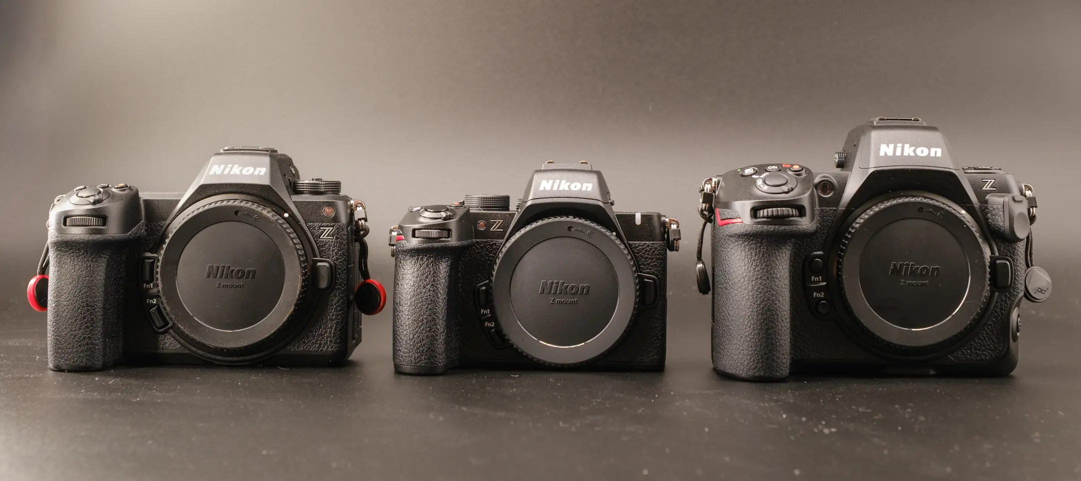 The Nikon Z50II next to the Nikon Z6III and Z8 on a black background