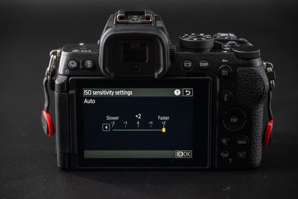 The rear of the Nikon Z50II camera with the Auto ISO sensitivity options shown. This shows the option to control auto ISO in increments ranging from slower to faster.