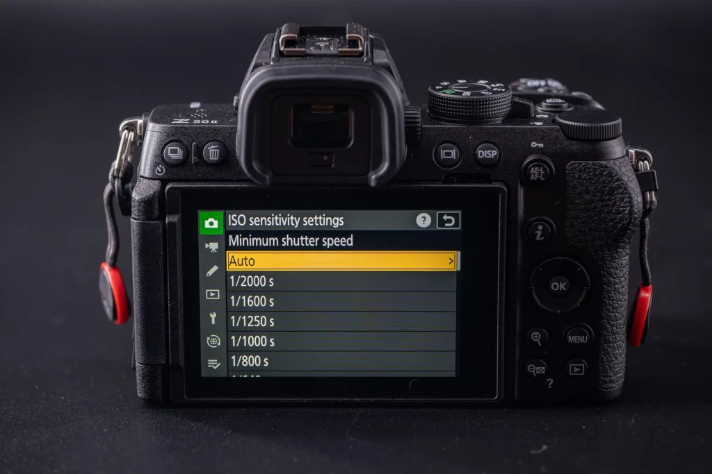 The rear of the Nikon Z50II with the rear LCD screen turned on and showing the ISO sensitivity options with Auto selected.
