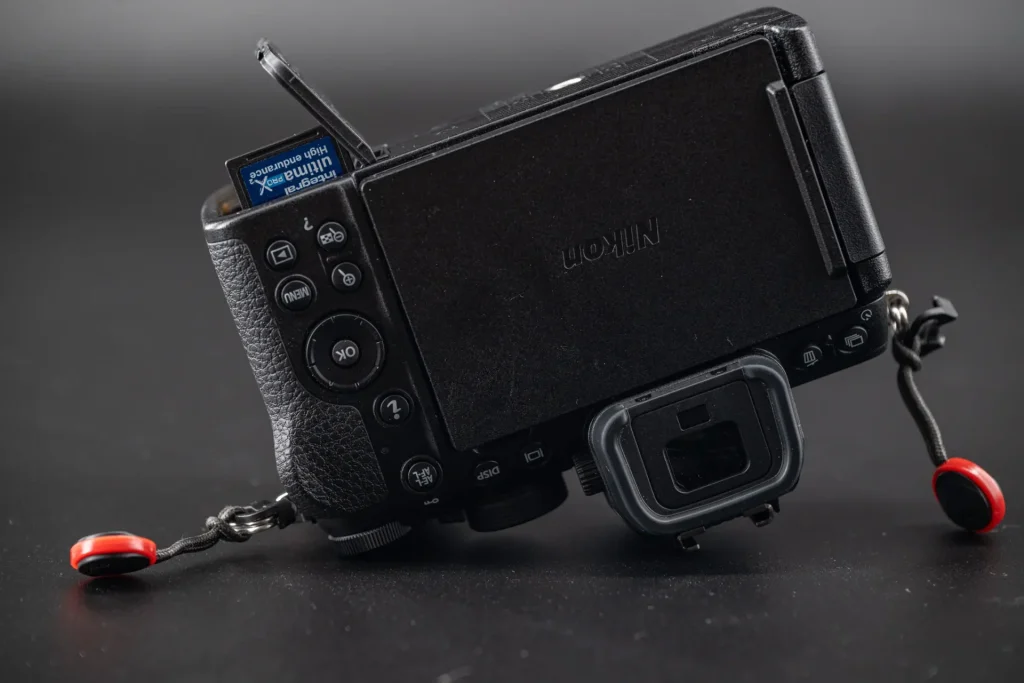 The Nikon Z50II with a memory card partially inserted in order to show the correct orientation for inserting memory cards.