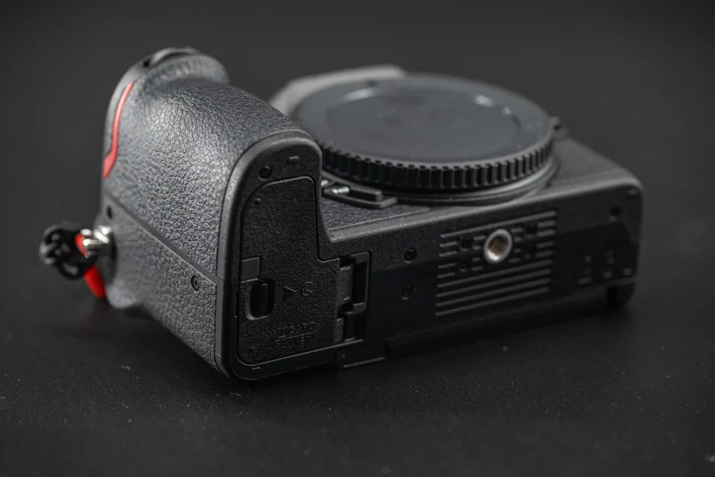 The bottom of the Nikon Z50II camera with battery compartment door now closed.