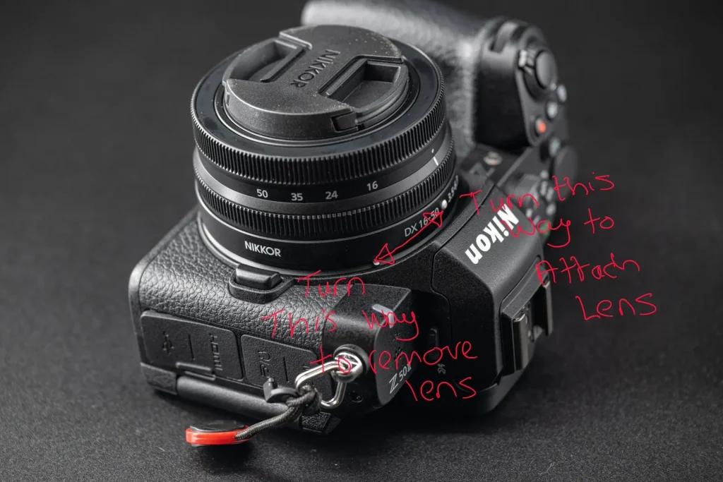 The same photo as above, that has been marked up with writing to explain which way to turn the lens in order to attach it to the Nikon Z50II camera.