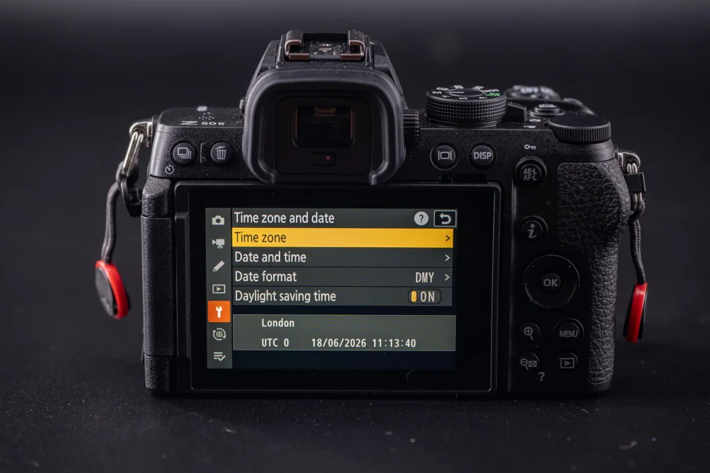 The rear screen of the Nikon Z50II, now showing the Time Zone and date menu.