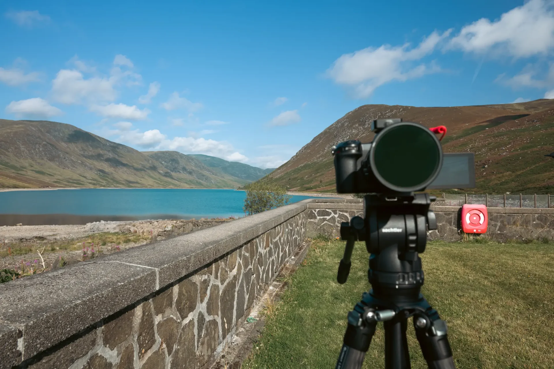 A photo of Loch Turret in Crieff, Scotland on a sunny day with a NIkon Z6III on top of a video tripod.